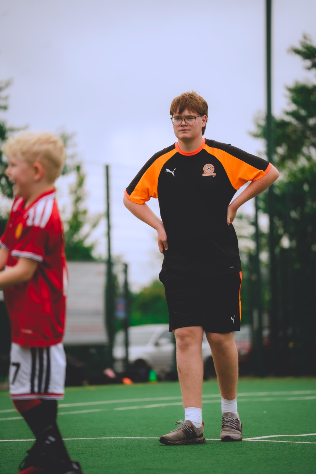 Coach Charlie observing and supporting a Beyond The Game football session