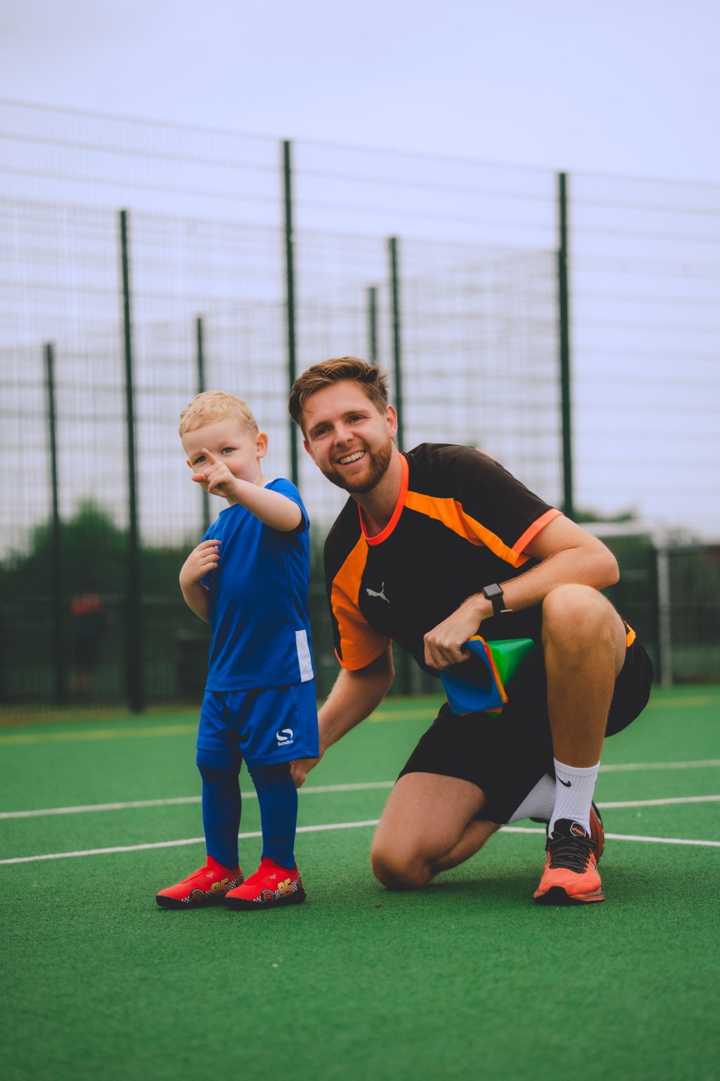 Coach Marc supporting a young footballer during a Beyond The Game session