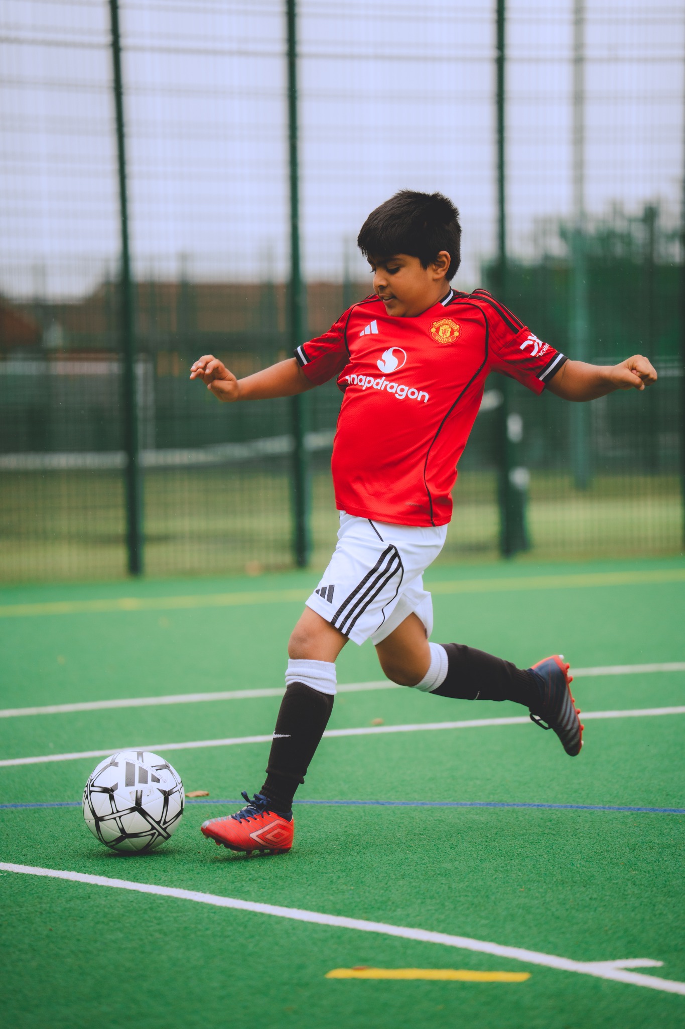 Zayd playing football during a Beyond The Game session